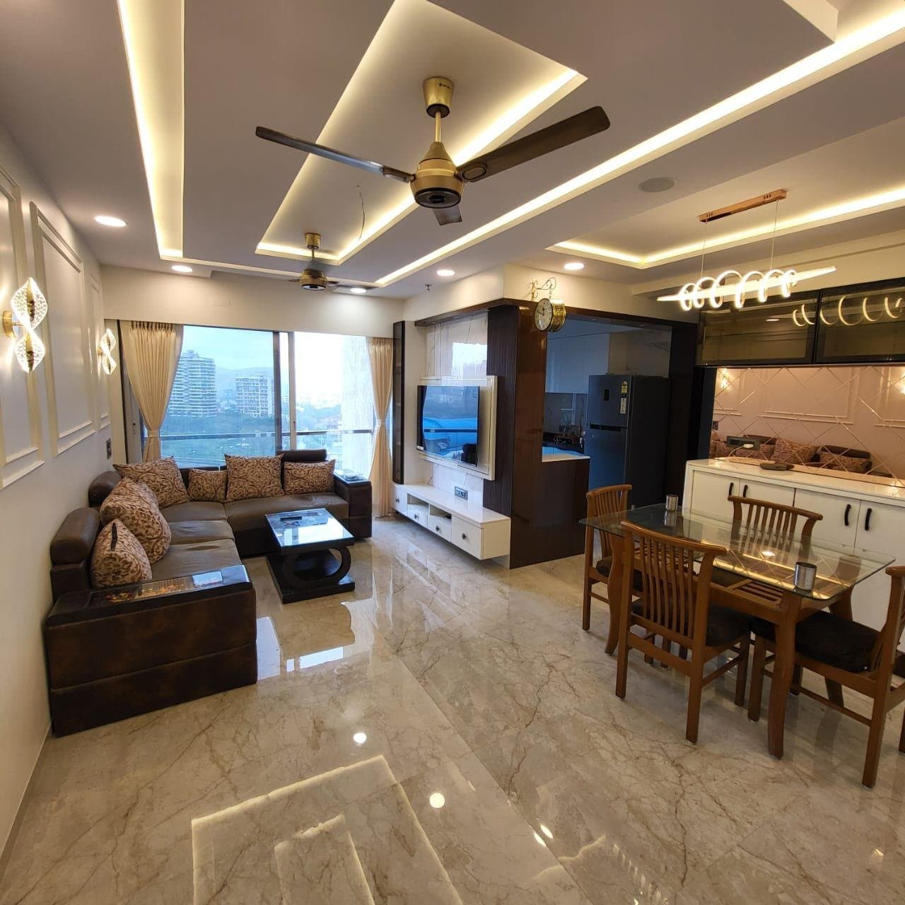 Open living and dining area with media unit, dining table, and view into the kitchen